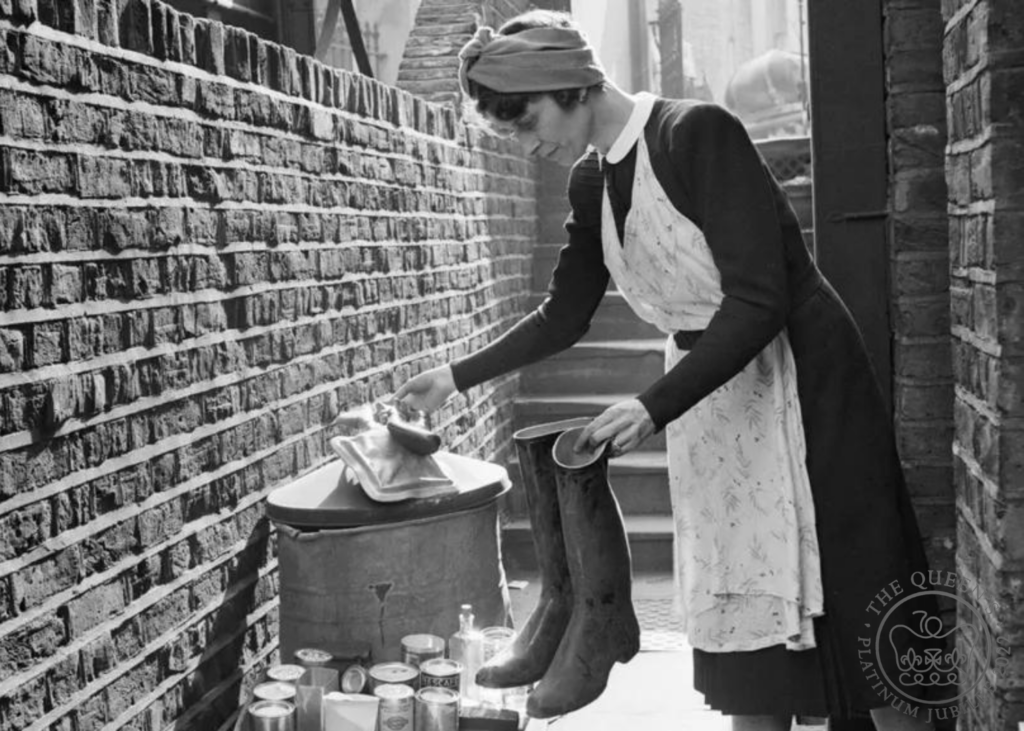A woman sorts items for salvage during the second world war. Ministry of Information.